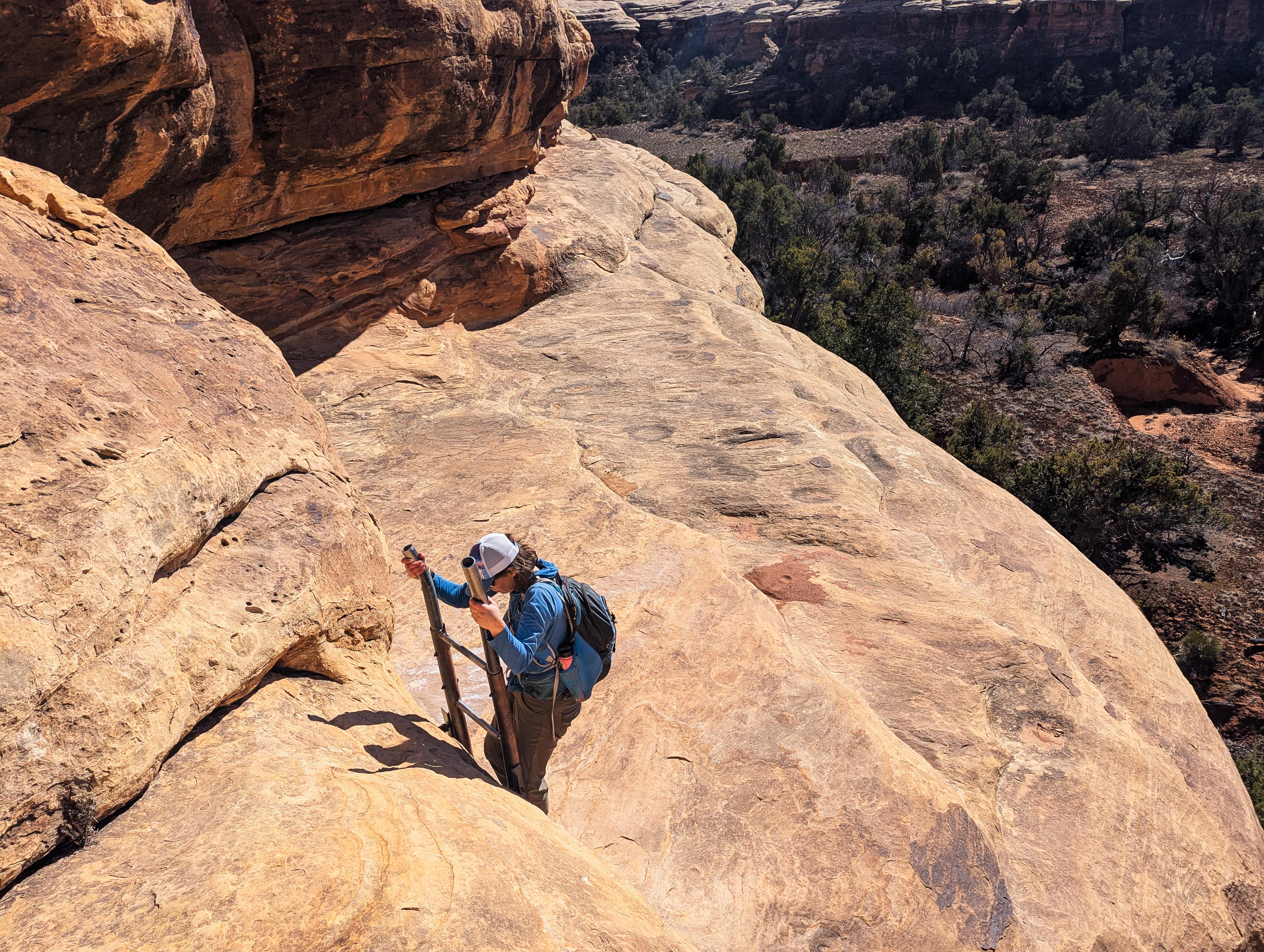 Diane on the ladder down to Lost Canyon